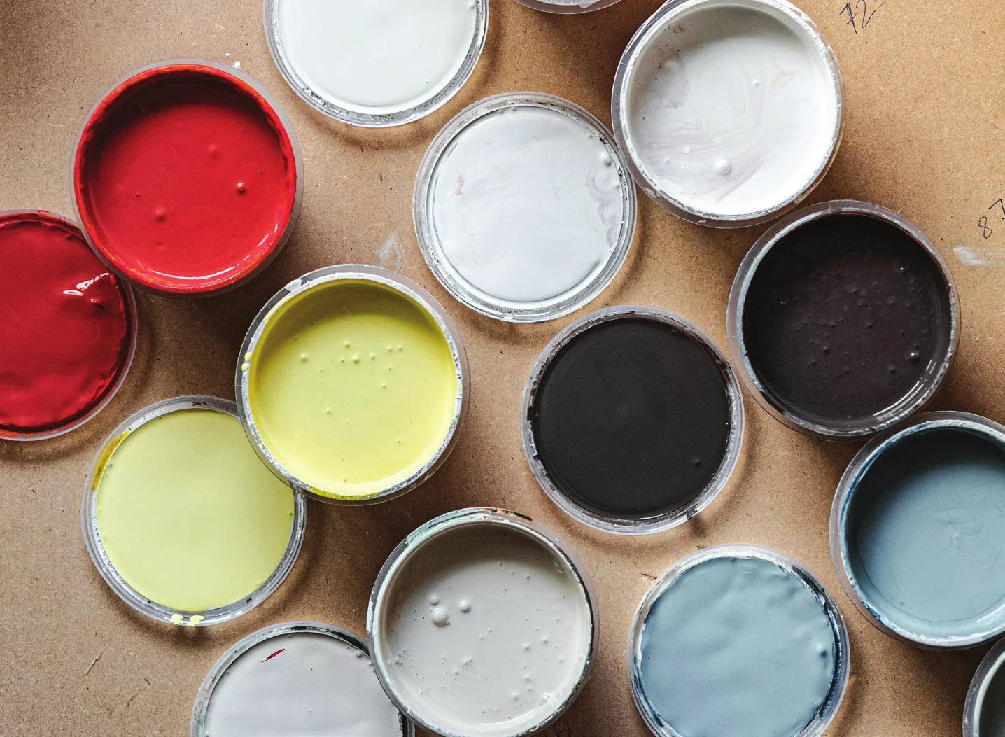 Open paint tins in a range of colors